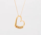 Heart necklace with engraved beads in gold